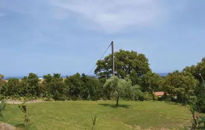 a field with a pole in the grass at Cozy Apartment In Talasani in Talasani