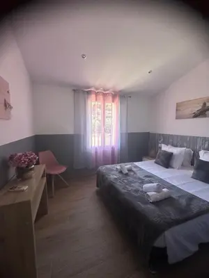 a bedroom with a large bed and a window at A Santa Trinita in Bonifacio