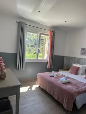 a bedroom with two beds and a window at A Santa Trinita in Bonifacio