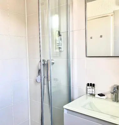 a bathroom with a shower and a sink at Hotel Les Pavillons Du Golfe in Favone