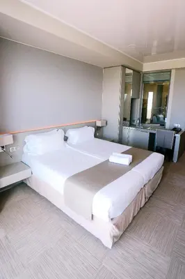a large white bed in a hotel room at Hôtel Cala di Sole in Ajaccio