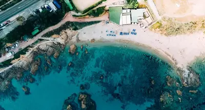 an aerial view of a beach with blue water at Hôtel Cala di Sole in Ajaccio