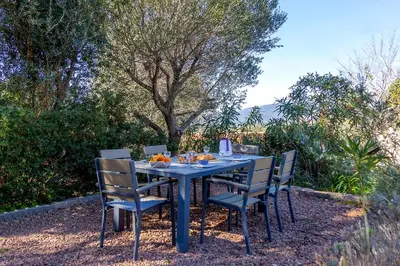 a blue table with chairs and fruit on it at Le moulin de Figari, nouvelle climatisation in Figari