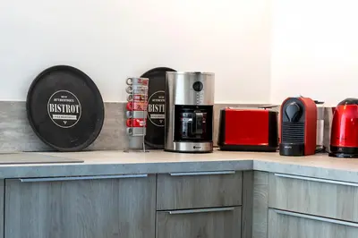 a kitchen counter with a coffee maker and a coffee pot at Le moulin de Figari, nouvelle climatisation in Figari