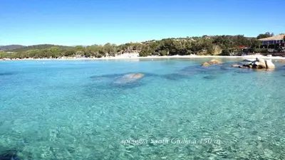a group of people swimming in the water on a beach at Minivilla Marina di Santa Giulia in Porto-Vecchio