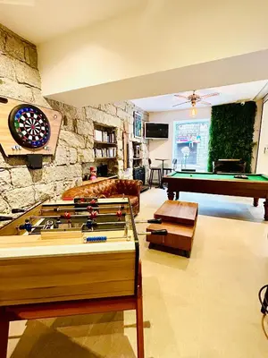 a living room with a pool table and a couch at Holzer II in Porto-Vecchio