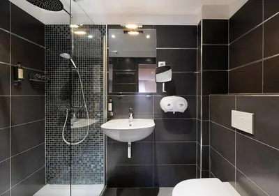 a bathroom with a sink and a shower and a toilet at Holzer II in Porto-Vecchio