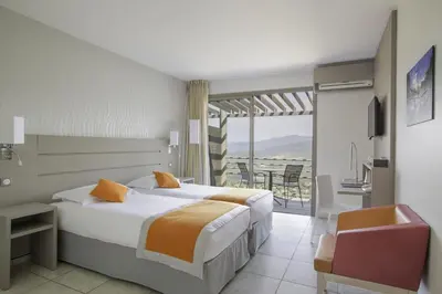 a hotel room with a bed and a balcony at Best Western Plus San Damianu in Sartène