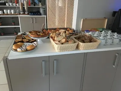 a table with baskets of different types of bread at Best Western Plus San Damianu in Sartène
