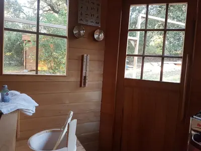 a bathroom with a toilet and two windows at Gites San Austinu in Petreto-Bicchisano