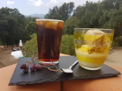 two drinks sitting on a table with a spoon at Gites San Austinu in Petreto-Bicchisano