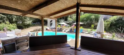 a patio with a swimming pool and a house at Gites San Austinu in Petreto-Bicchisano