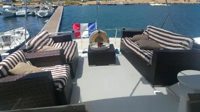 two chairs and a table on the deck of a boat at Ocean Yacht Trawler - Le Caloa in Porto-Vecchio