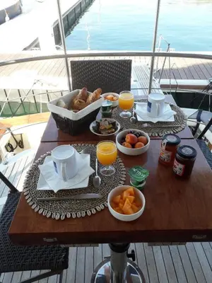 a table with a breakfast of food and orange juice at Ocean Yacht Trawler - Le Caloa in Porto-Vecchio