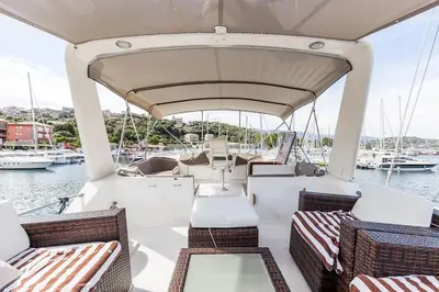 a boat with chairs and tables on a body of water at Ocean Yacht Trawler - Le Caloa in Porto-Vecchio