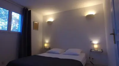 a bedroom with a bed with two pillows and a window at residence stella d'oro in Porto-Vecchio
