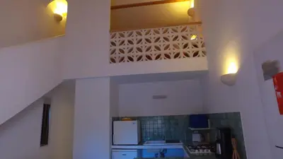 a kitchen with a sink and a white refrigerator at residence stella d'oro in Porto-Vecchio