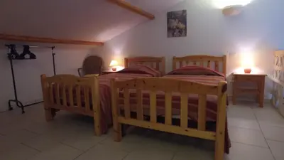 a bedroom with two wooden beds in a room at residence stella d'oro in Porto-Vecchio