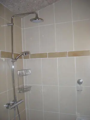a shower with a glass door in a bathroom at Maisonnette du berger de Croccano in Sartène