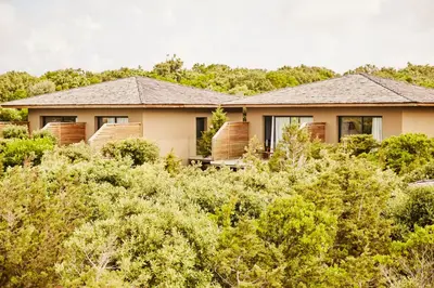 a house in the middle of the bushes at Hôtel & Spa Version Maquis Citadelle in Bonifacio