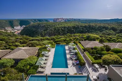 an aerial view of the pool at a resort with a view at Hôtel & Spa Version Maquis Citadelle in Bonifacio