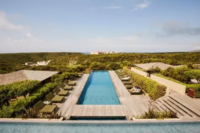 an overhead view of a swimming pool with chaise lounge chairs at Hôtel & Spa Version Maquis Citadelle in Bonifacio