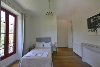 a bedroom with two beds and a fireplace at Le Vizzavona in Vizzavona