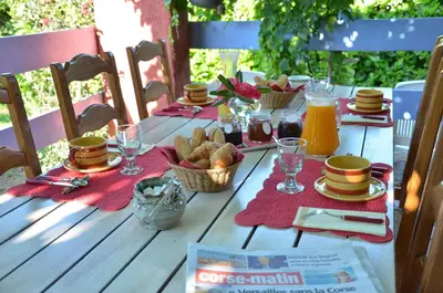 a wooden table with food and drinks on it at CASA-CORSA chambre d'hote in Cervione