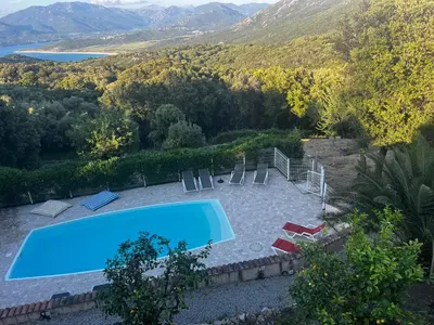 a swimming pool with chairs and a view of a mountain at Chez Marc et Jeannick in Belvédère