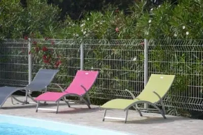 a group of chairs sitting next to a swimming pool at Chez Marc et Jeannick in Belvédère