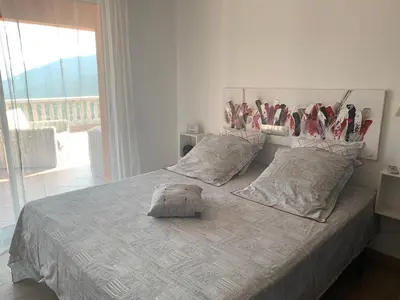 a bedroom with a bed with hockey bats on the wall at Chez Marc et Jeannick in Belvédère
