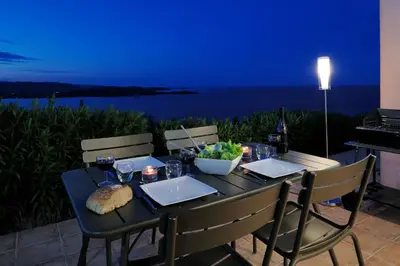 a table with glasses of wine and a bowl of food at Résidence MARINA SERENA in Porto-Vecchio