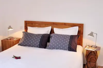 a bedroom with a white bed with two pillows at Résidence MARINA SERENA in Porto-Vecchio
