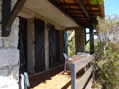 a porch with a bench and a door at VbyOnyx in Olmeto