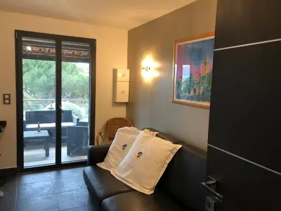 a living room with a couch with two pillows on it at VbyOnyx in Olmeto