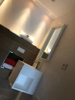 a kitchen with a white refrigerator and a mirror at VbyOnyx in Olmeto