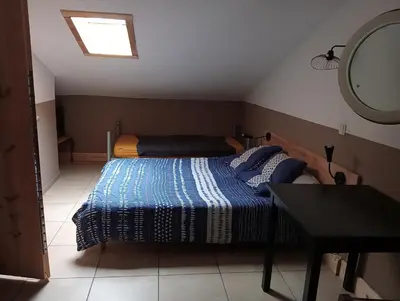 a small bedroom with a bed and a mirror at Berbi Rosse in Oletta