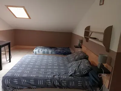 a bedroom with two beds and a desk and a bed at Berbi Rosse in Oletta