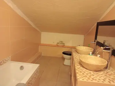 a bathroom with two sinks and a toilet and a tub at Berbi Rosse in Oletta