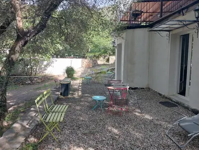 a group of chairs and tables in a yard at Berbi Rosse in Oletta