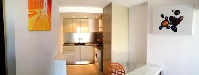 a small kitchen with a sink and a refrigerator at Maison de Vacances - Casa Mezanaccia avec Terrasse fleurie meublé tourisme 3 étoiles in Santa-Lucia-di-Tallano