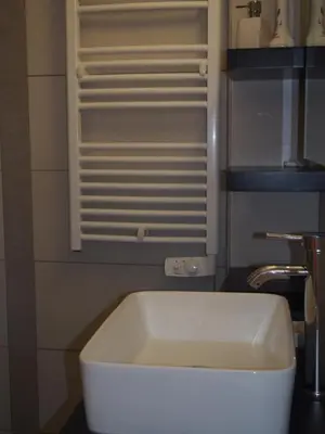 a white bath tub sitting next to a sink at Maison de Vacances - Casa Mezanaccia avec Terrasse fleurie meublé tourisme 3 étoiles in Santa-Lucia-di-Tallano