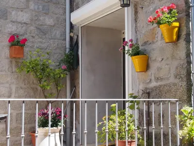 a house with flower pots on the front door at Maison de Vacances - Casa Mezanaccia avec Terrasse fleurie meublé tourisme 3 étoiles in Santa-Lucia-di-Tallano