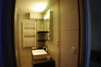 a bathroom with a sink and a mirror at Maison de Vacances - Casa Mezanaccia avec Terrasse fleurie meublé tourisme 3 étoiles in Santa-Lucia-di-Tallano