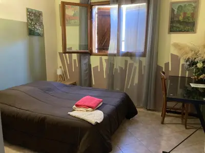 a bedroom with a bed with a red towel on it at Macchia Évasion avec piscine in Monacia-dʼAullène