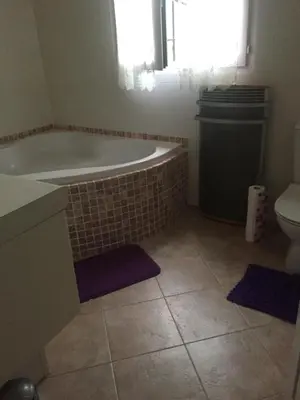 a bathroom with a tub and a toilet at Macchia Évasion avec piscine in Monacia-dʼAullène