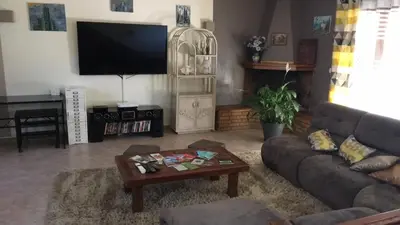 a living room with a couch and a coffee table at Macchia Évasion avec piscine in Monacia-dʼAullène