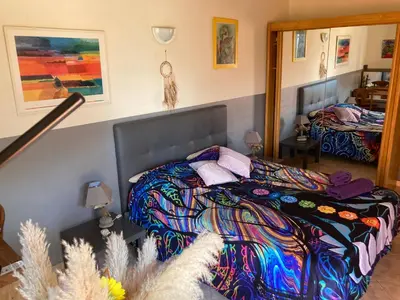 a bedroom with a bed with a colorful blanket at Macchia Évasion avec piscine in Monacia-dʼAullène