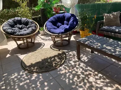 two chairs and a table on a patio at Macchia Évasion avec piscine in Monacia-dʼAullène