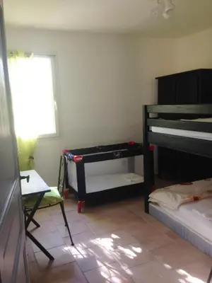 a room with two bunk beds and a window at Villa SERENA in Sarrola-Carcopino